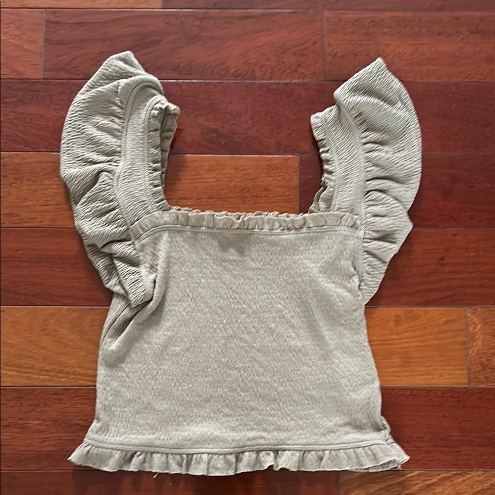 Cute tan crop top with ruffle style. NWOT. Size XS